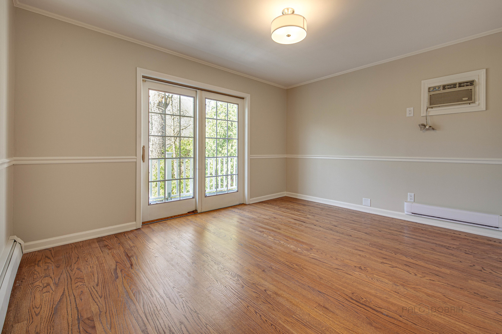 1417 Tower Road Winnetka, IL 60093 - Photo 24 of 39 an empty room with wooden floor and windows