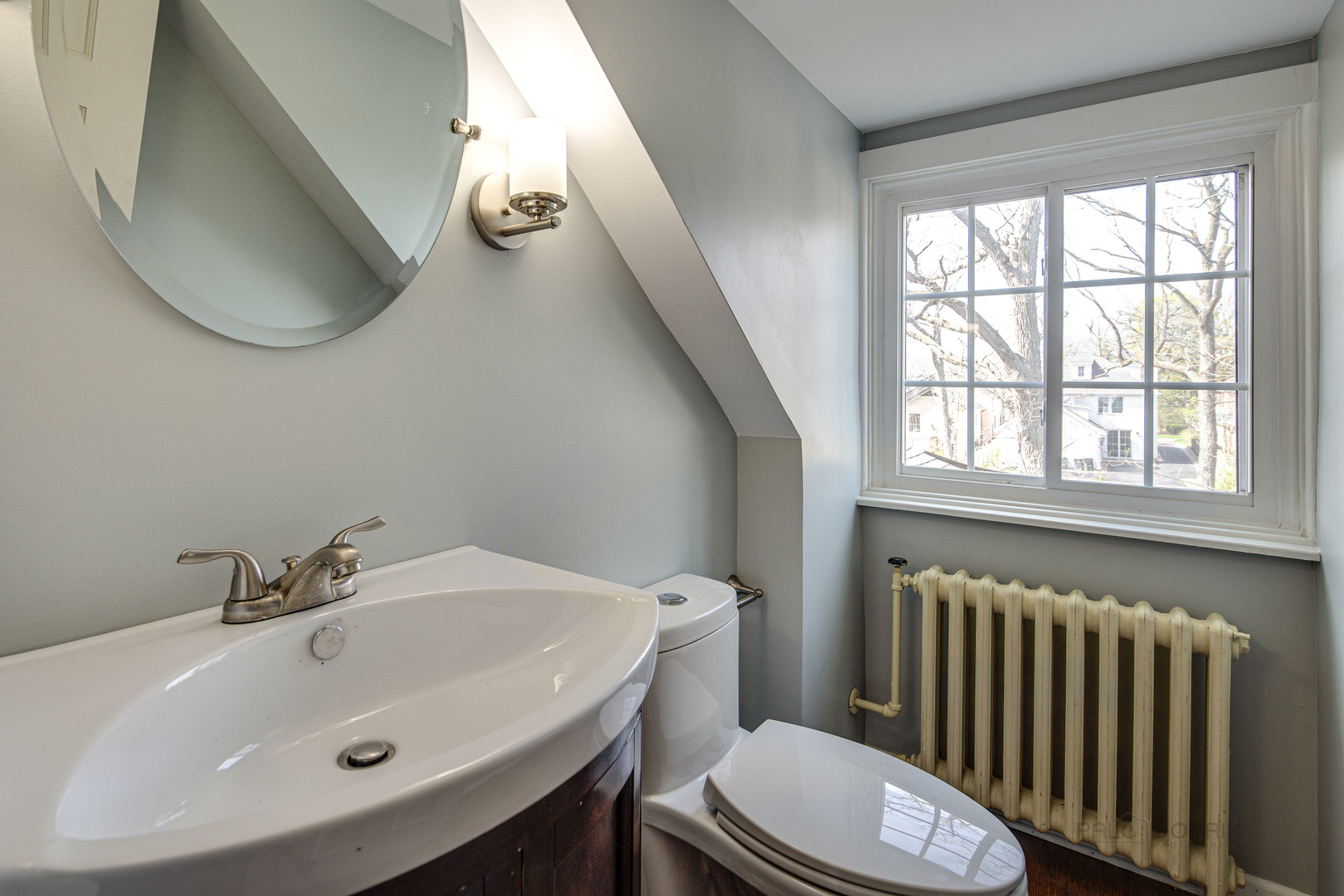 1417 Tower Road Winnetka, IL 60093 - Photo 29 of 39 a bathroom with a sink a toilet and a window