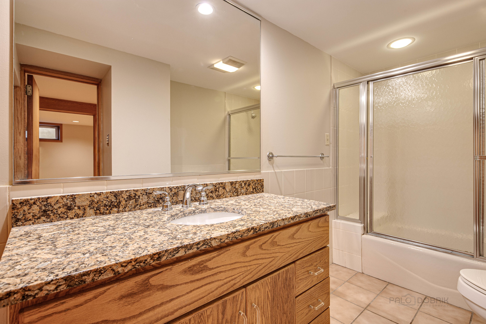 1417 Tower Road Winnetka, IL 60093 - Photo 31 of 39 a bathroom with a granite countertop sink and a mirror