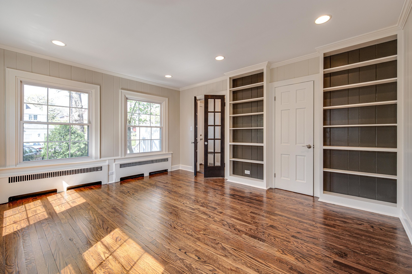 1417 Tower Road Winnetka, IL 60093 - Photo 8 of 39 wooden floor in an empty room with a window