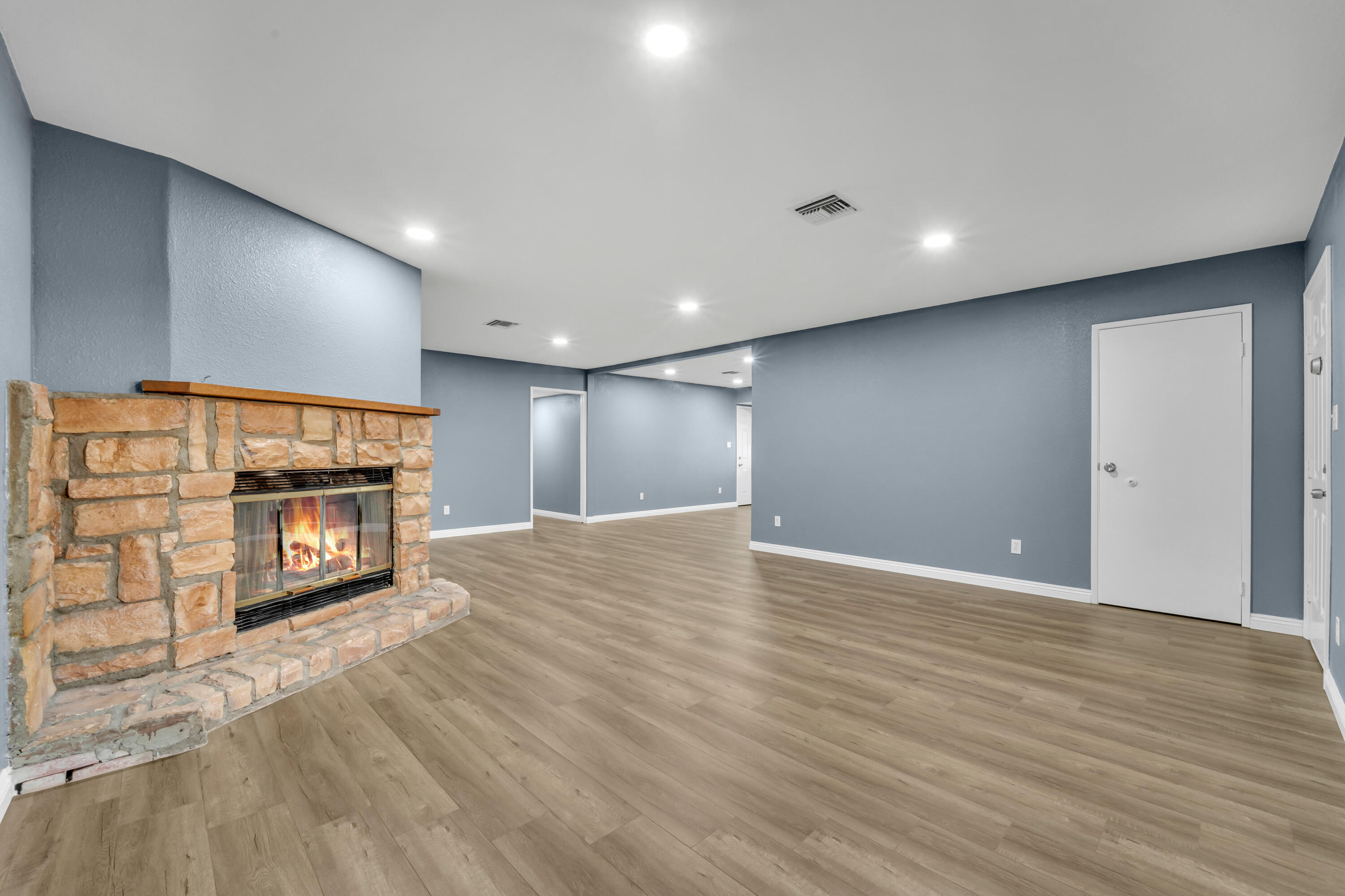 1032 South Farragut Street Ridgecrest, CA 93555 - Photo 3 of 32 a view of an empty room with wooden floor
