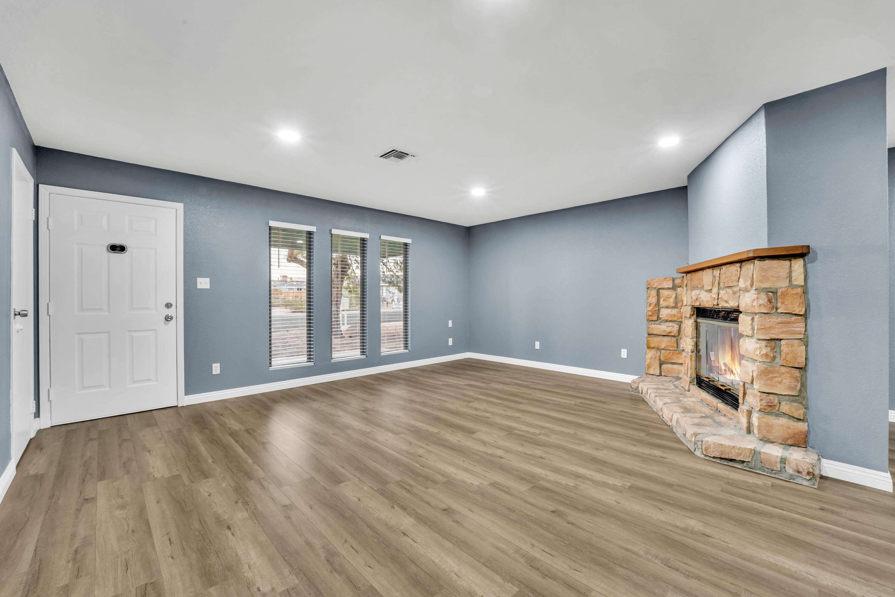 1032 South Farragut Street Ridgecrest, CA 93555 - Photo 4 of 32 a view of an empty room with wooden floor and a window