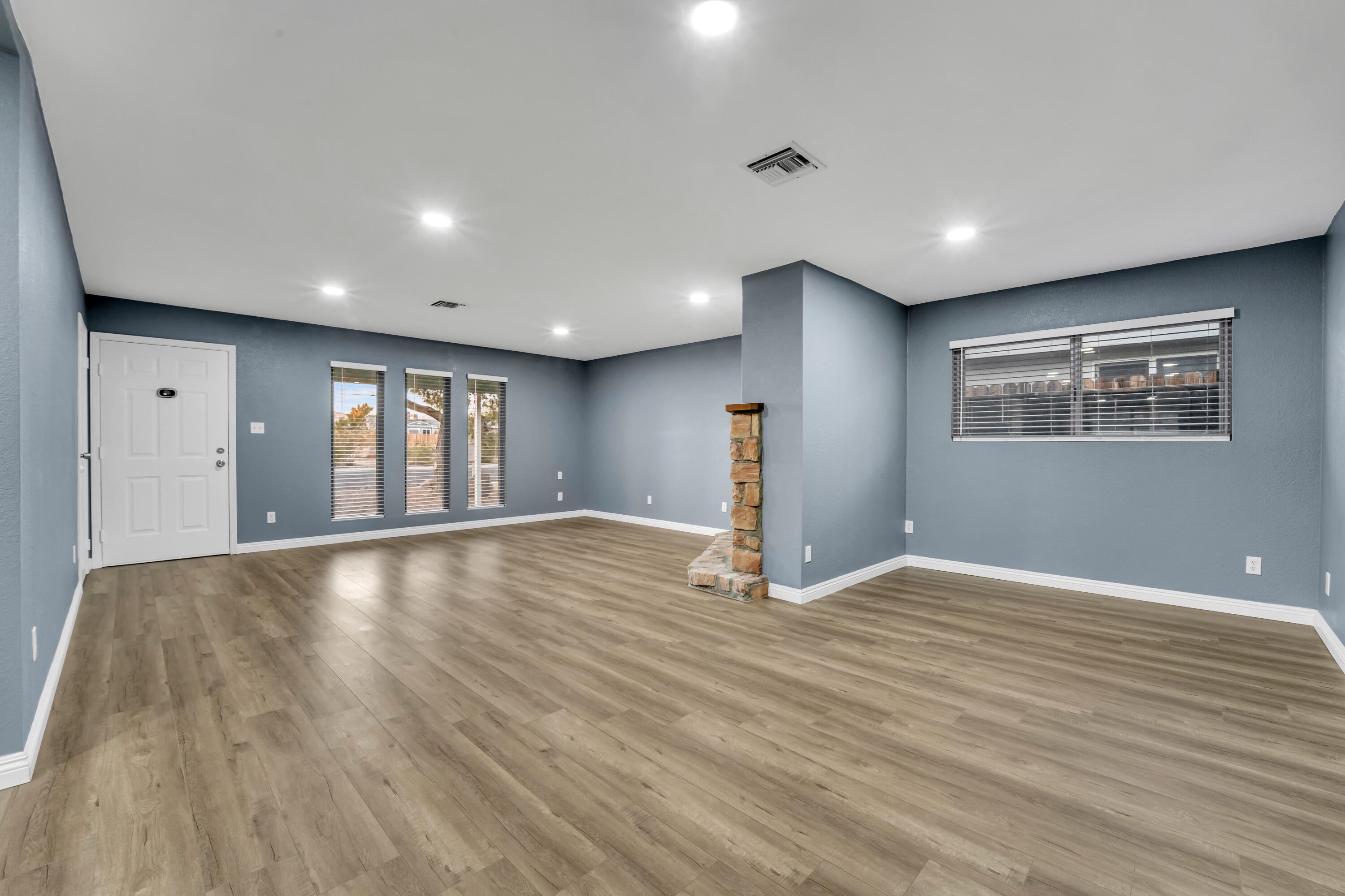 1032 South Farragut Street Ridgecrest, CA 93555 - Photo 5 of 32 a view of an empty room with wooden floor and a window