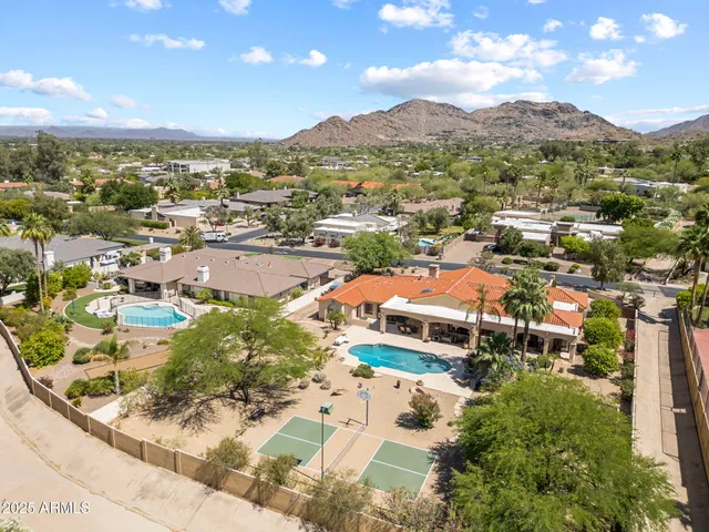 a living room with furniture chandelier and a fireplace
