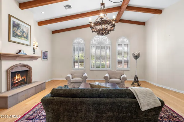 a living room with furniture fireplace and flat screen tv