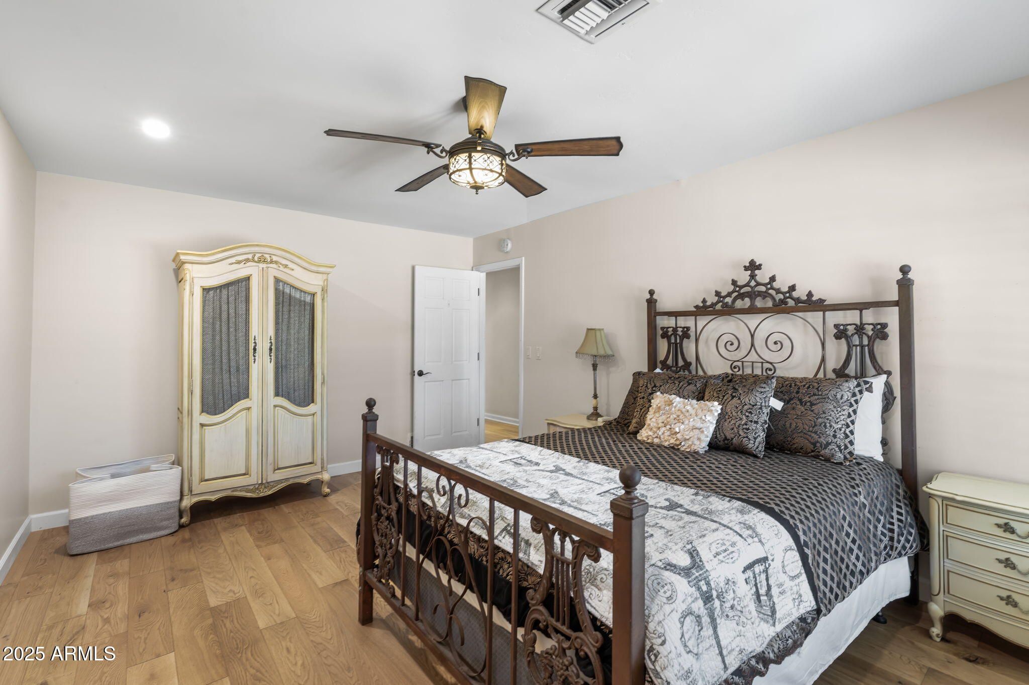 4520 East Horseshoe Road Phoenix, AZ 85028 - Photo 25 of 50 a bedroom with a bed and wooden floor