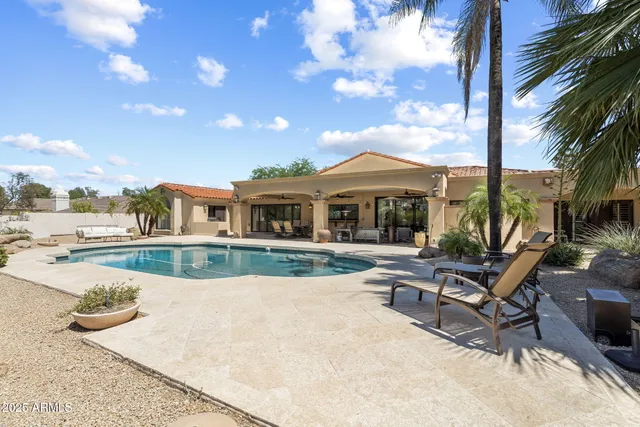 a kitchen with stainless steel appliances granite countertop a sink a stove and a refrigerator