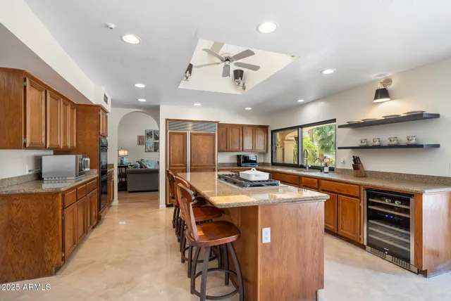 a dining room with furniture a chandelier and wooden floor