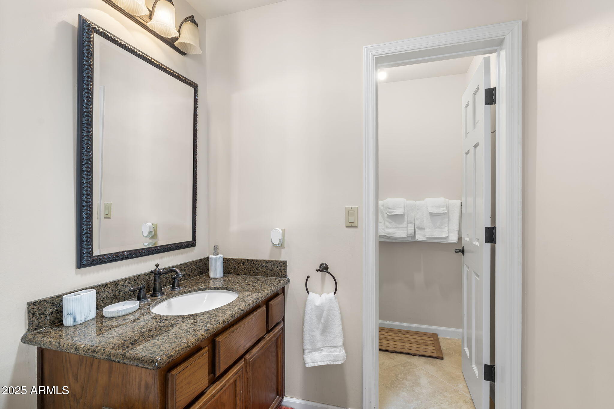 4520 East Horseshoe Road Phoenix, AZ 85028 - Photo 4 of 50 a bathroom with a granite countertop sink and a mirror