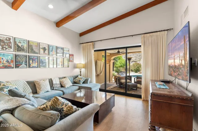 a bedroom with a bed and a television on dresser