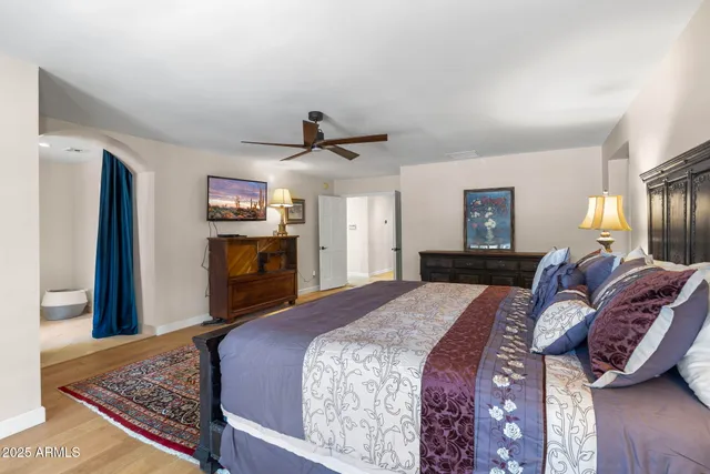 a room with a desk chairs and chandelier