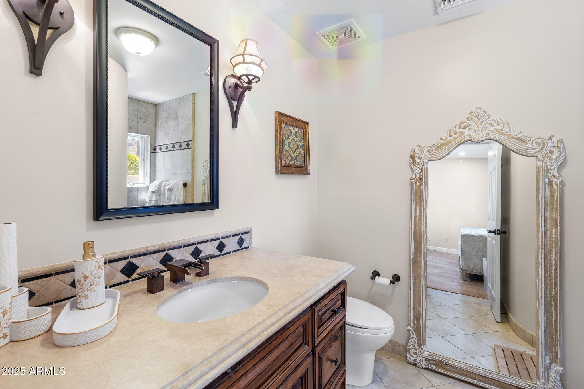 4520 East Horseshoe Road Phoenix, AZ 85028 - Photo 7 of 50 a bathroom with a granite countertop toilet sink and mirror