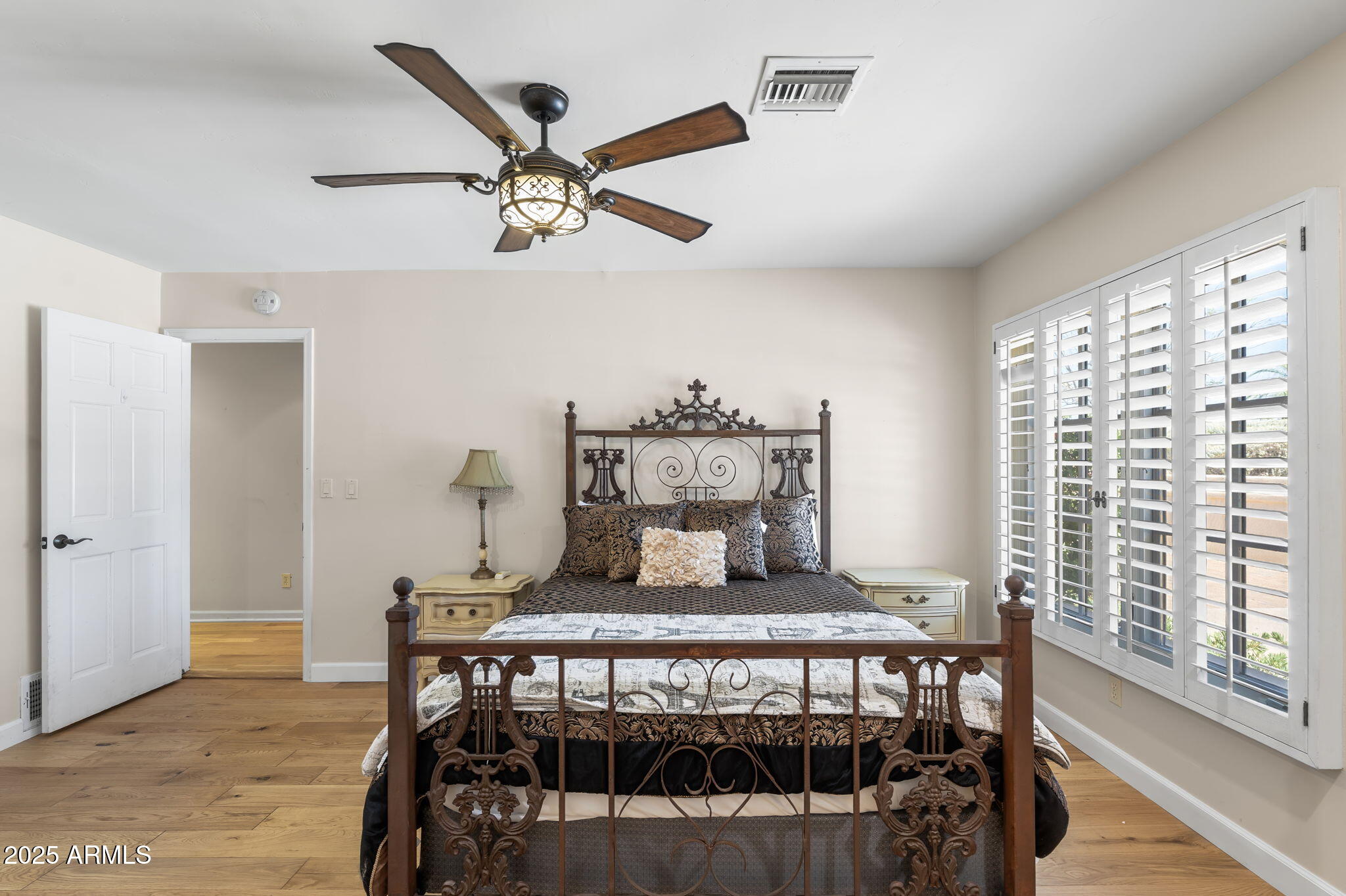 4520 East Horseshoe Road Phoenix, AZ 85028 - Photo 8 of 50 a bedroom with a bed and wooden floor