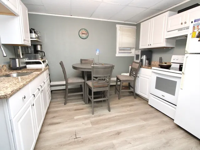 a kitchen with cabinets appliances and a window