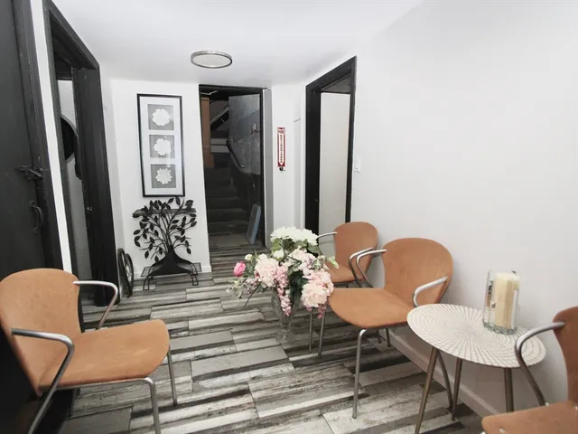 a dining room with furniture and wooden floor