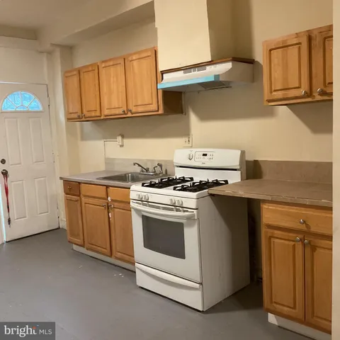 a kitchen with stainless steel appliances granite countertop a stove and a sink