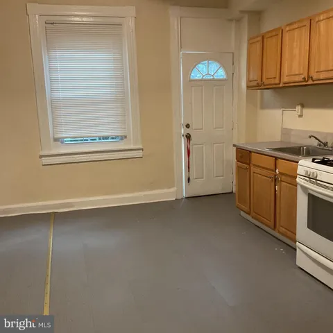 a kitchen with white cabinets and a stove