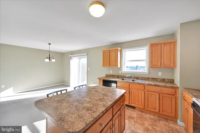 a kitchen with kitchen island a sink stove and cabinets