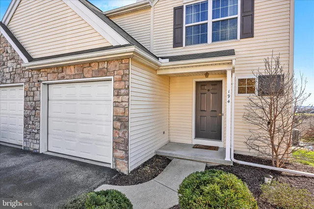 a view of small house with garage
