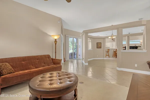 a living room with furniture and a glass door