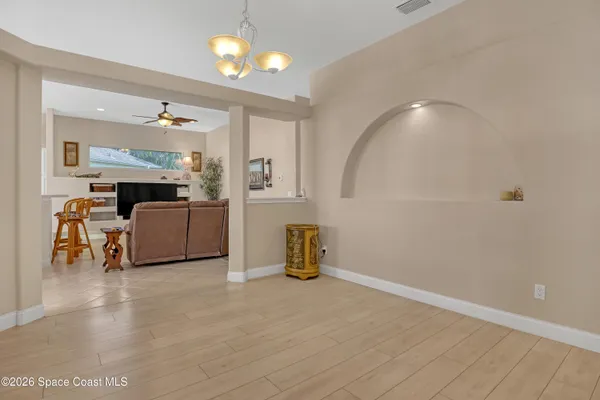 a view of a livingroom with furniture and a ceiling fan