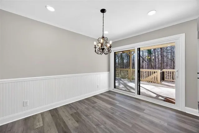 a view of a room with wooden floor and fan