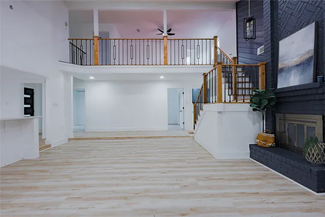 a view of staircase with railing and white walls