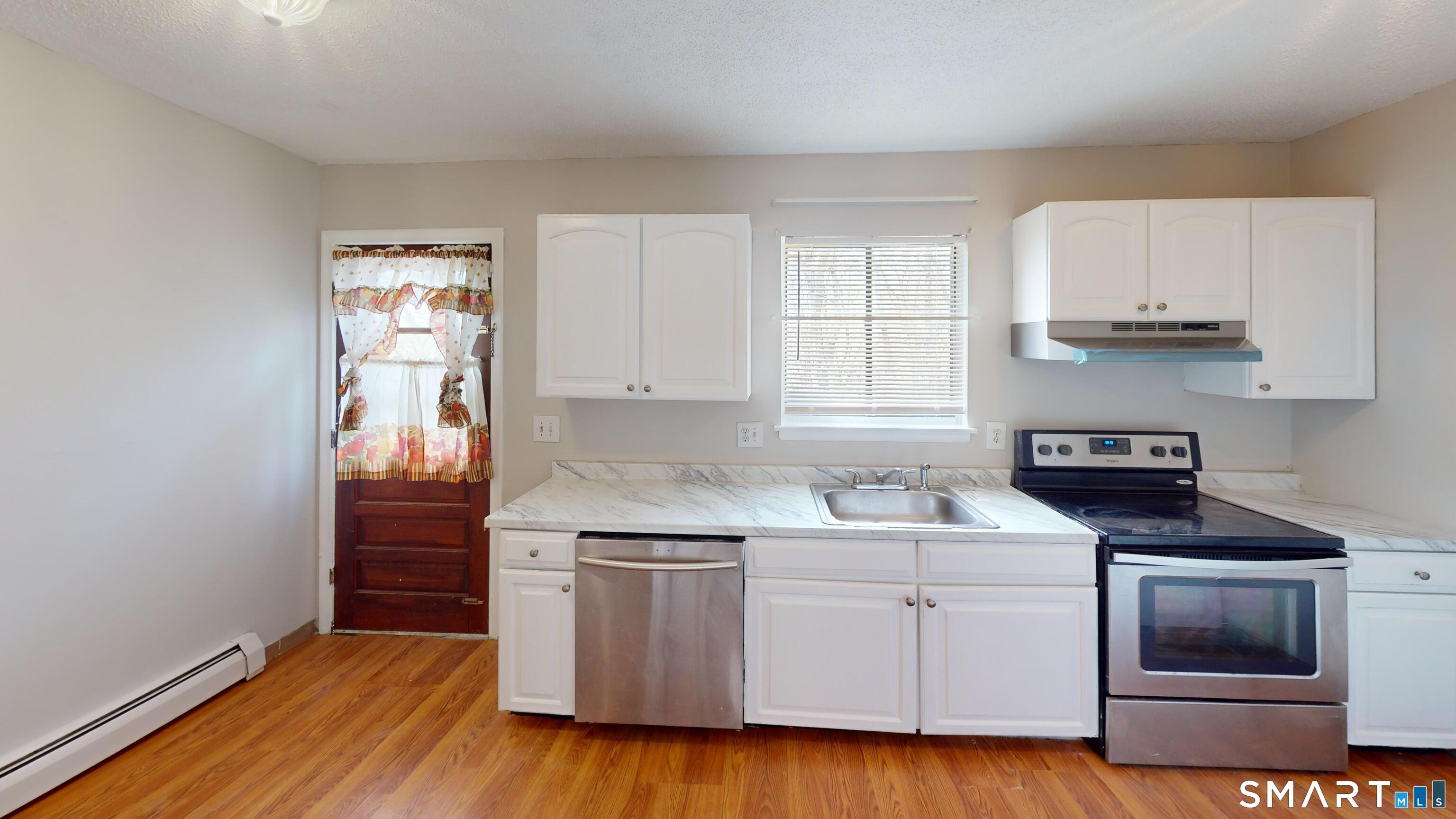 158 High Path Road, Unit 158 Windsor, CT 06095 - Photo 5 of 20 a kitchen with white cabinets stainless steel appliances and sink
