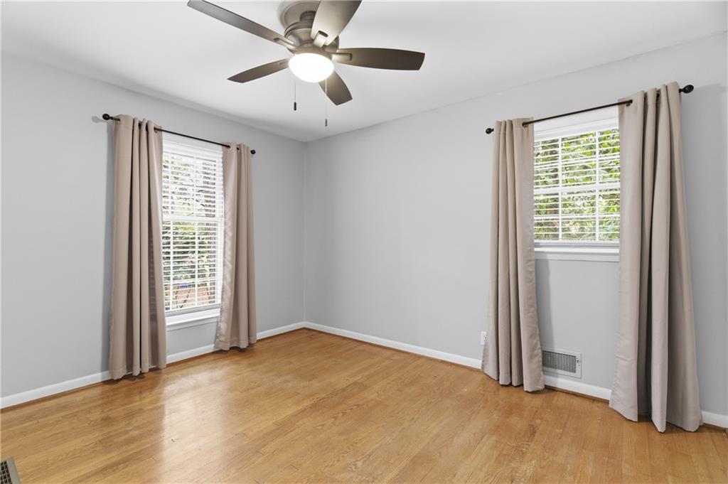 3698 Embry Circle Chamblee, GA 30341 - Photo 8 of 20 a view of an empty room with a window and wooden floor