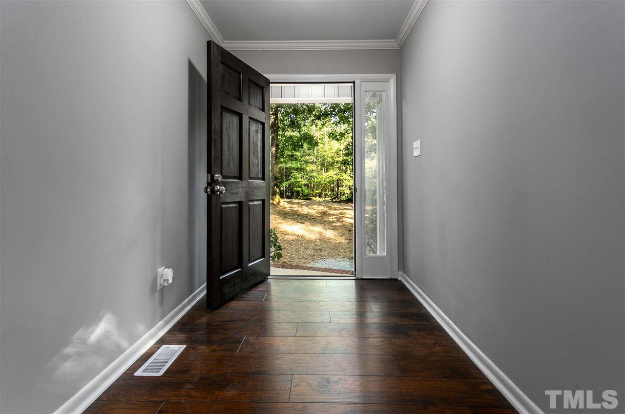 1016 Reca Road Garner, NC 27529 - Photo 8 of 25 a view of hallway with wooden floor and stairs