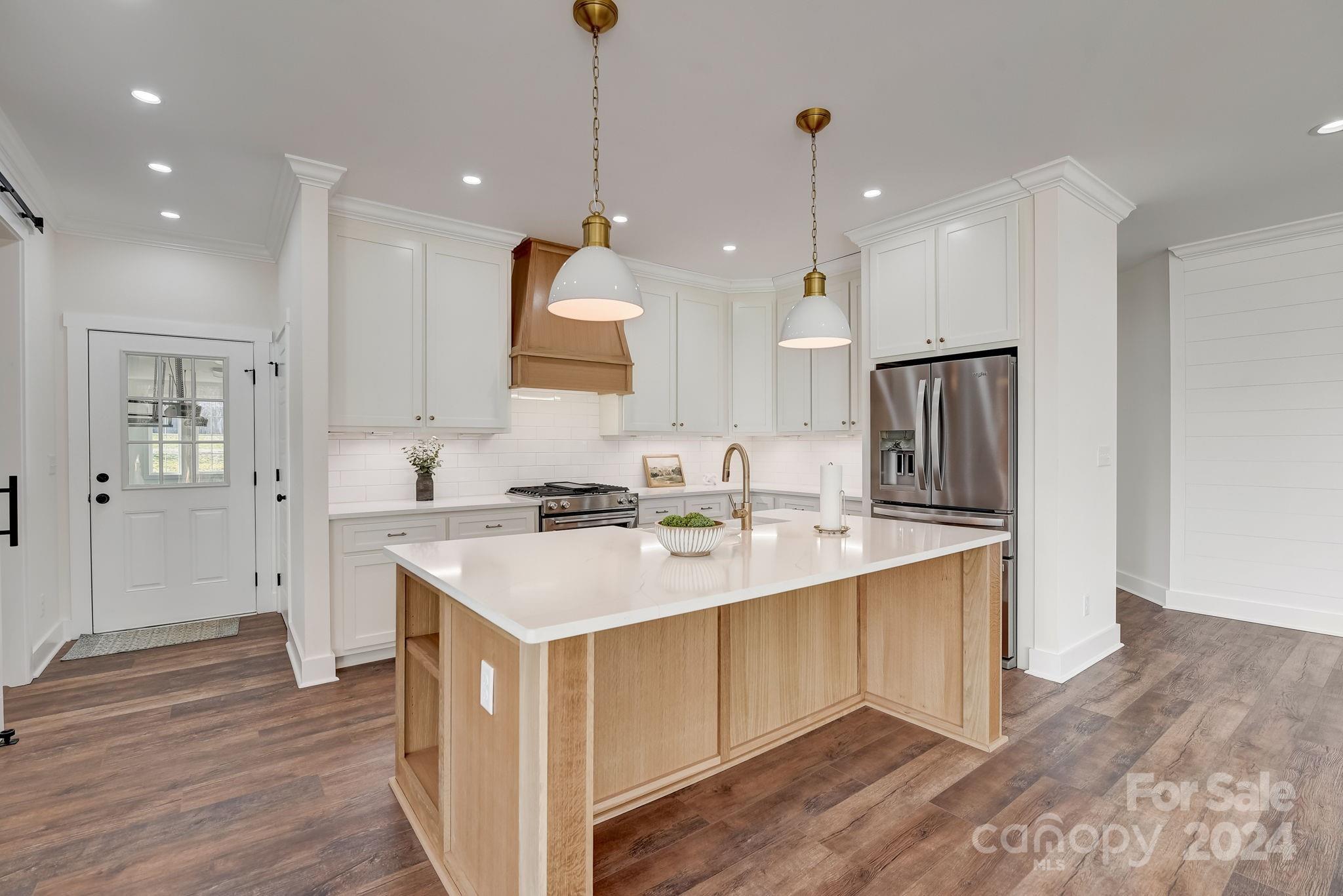 315 Cal Kennedy Road Cleveland, NC 27013 - Photo 11 of 39 a kitchen with kitchen island a sink and a stove top oven