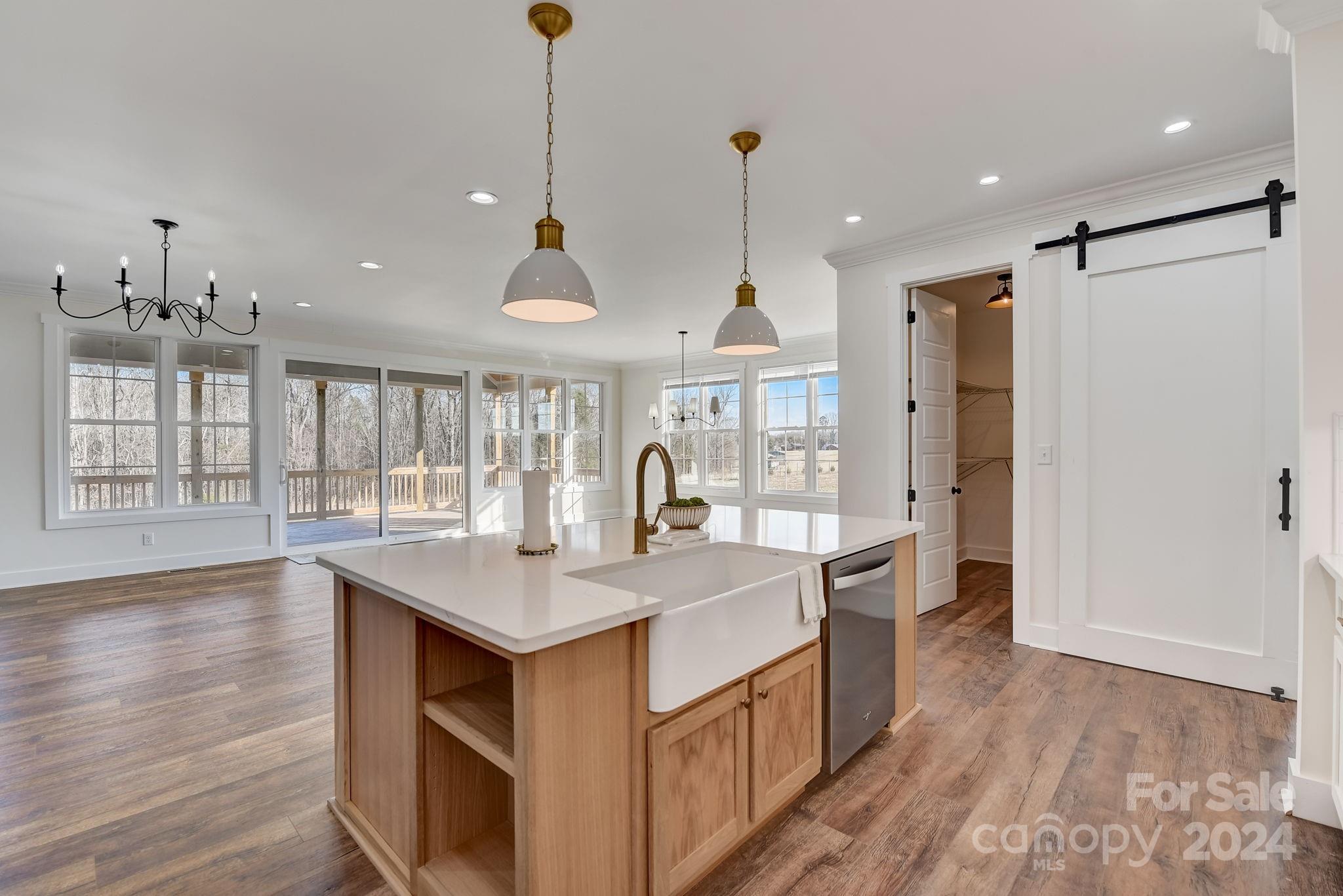315 Cal Kennedy Road Cleveland, NC 27013 - Photo 13 of 39 a large kitchen with kitchen island a stove a sink a center island and wooden floor