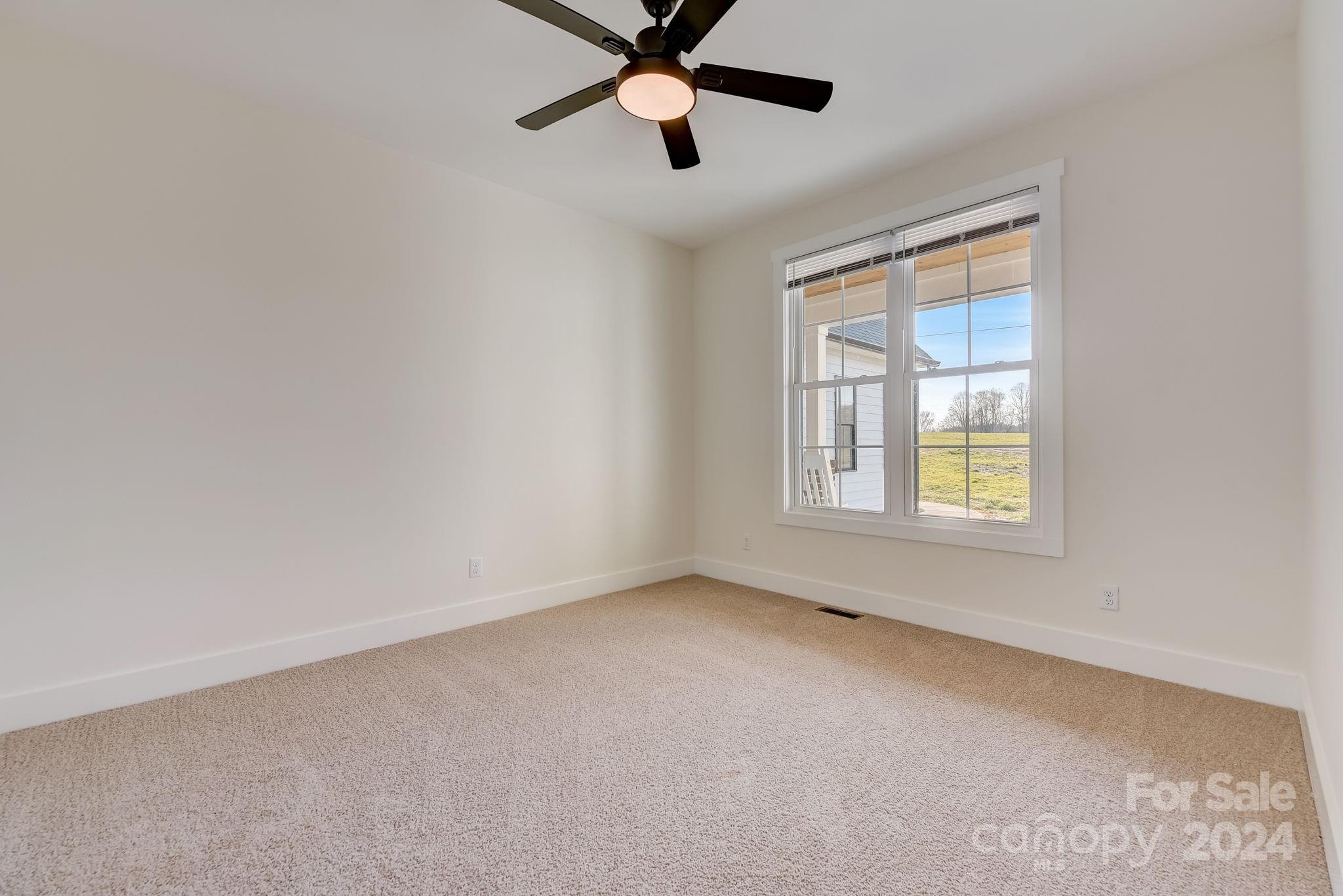 315 Cal Kennedy Road Cleveland, NC 27013 - Photo 18 of 39 an empty room with windows and fan