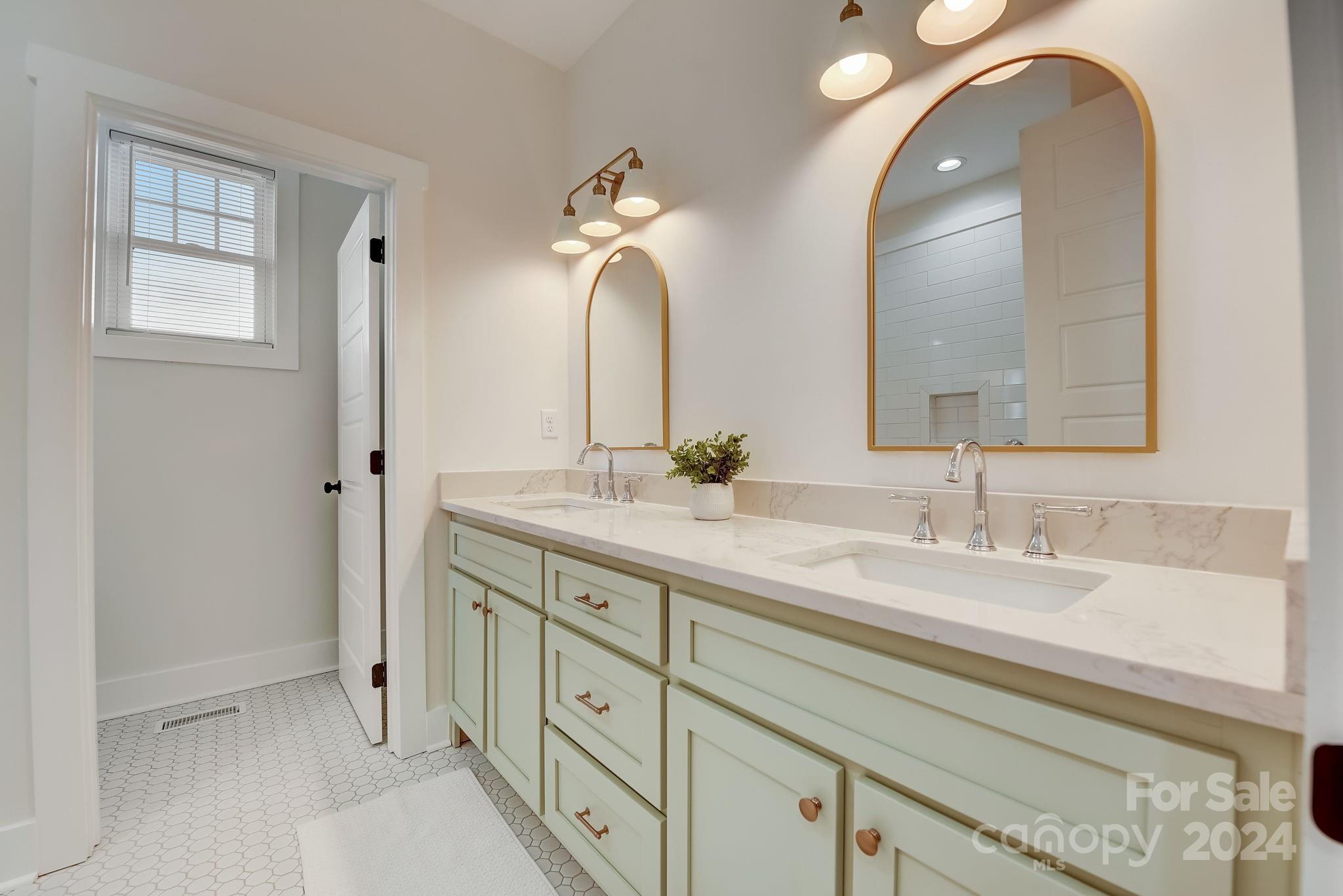 315 Cal Kennedy Road Cleveland, NC 27013 - Photo 20 of 39 a bathroom with a double vanity sink and a mirror