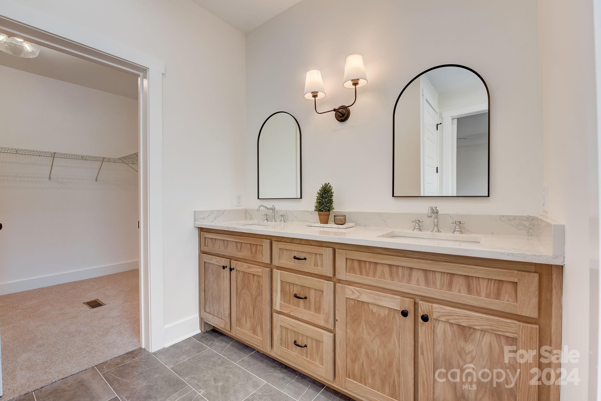 315 Cal Kennedy Road Cleveland, NC 27013 - Photo 22 of 39 a bathroom with a double vanity sink and a mirror