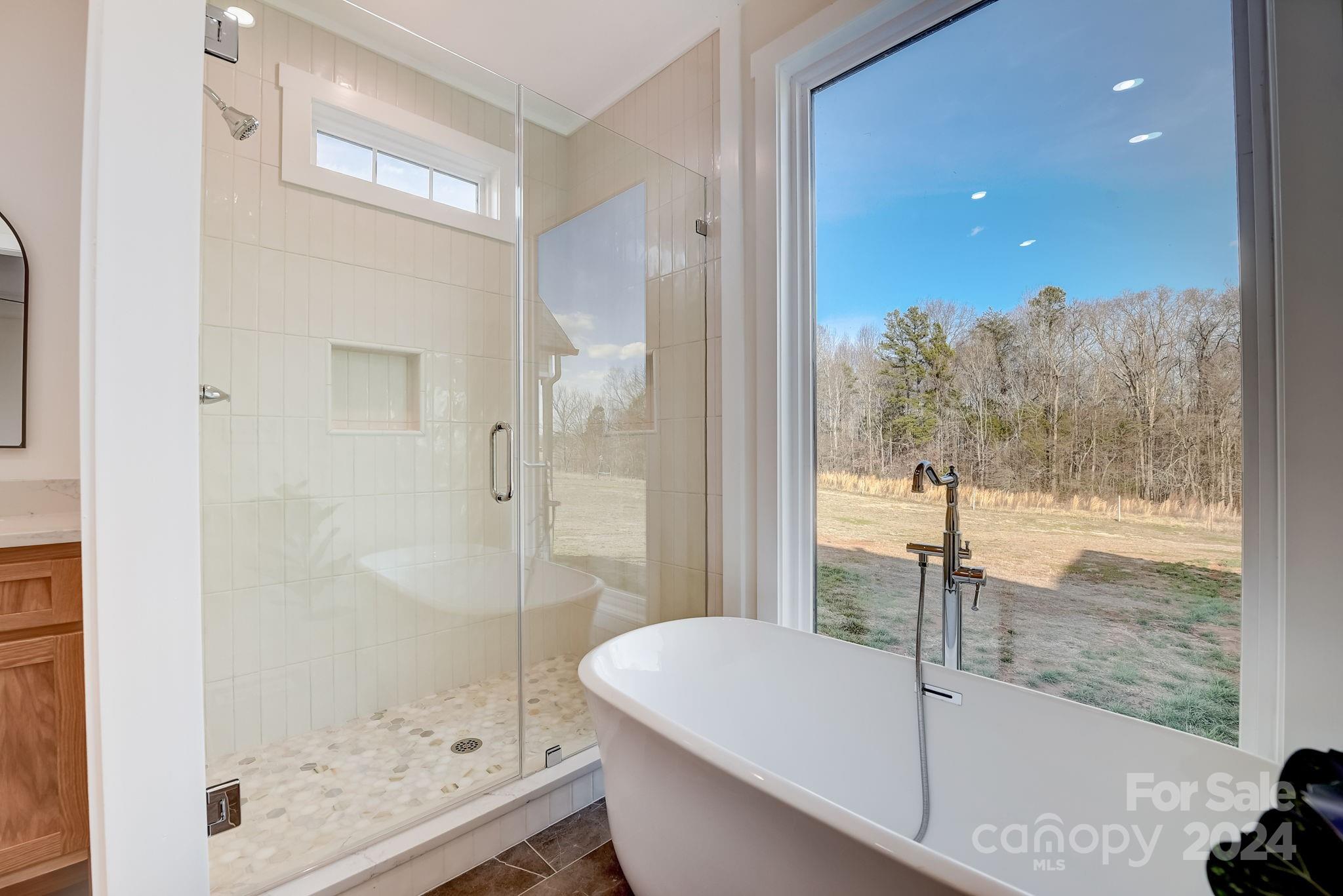 315 Cal Kennedy Road Cleveland, NC 27013 - Photo 23 of 39 a bathroom with a bathtub and a shower