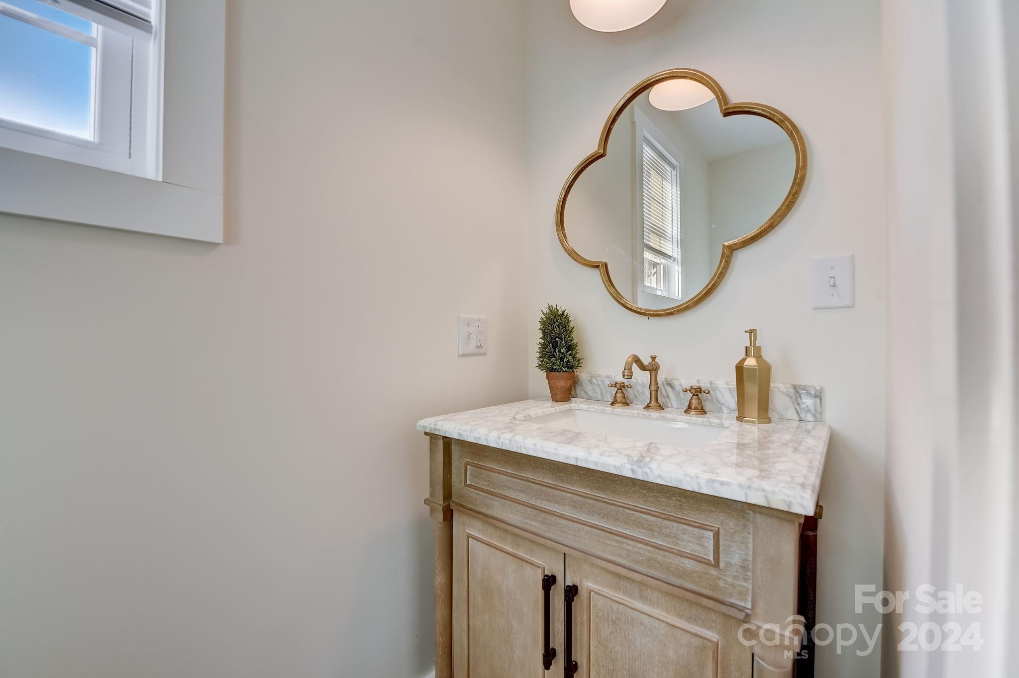 315 Cal Kennedy Road Cleveland, NC 27013 - Photo 26 of 39 a bathroom with a sink and a mirror