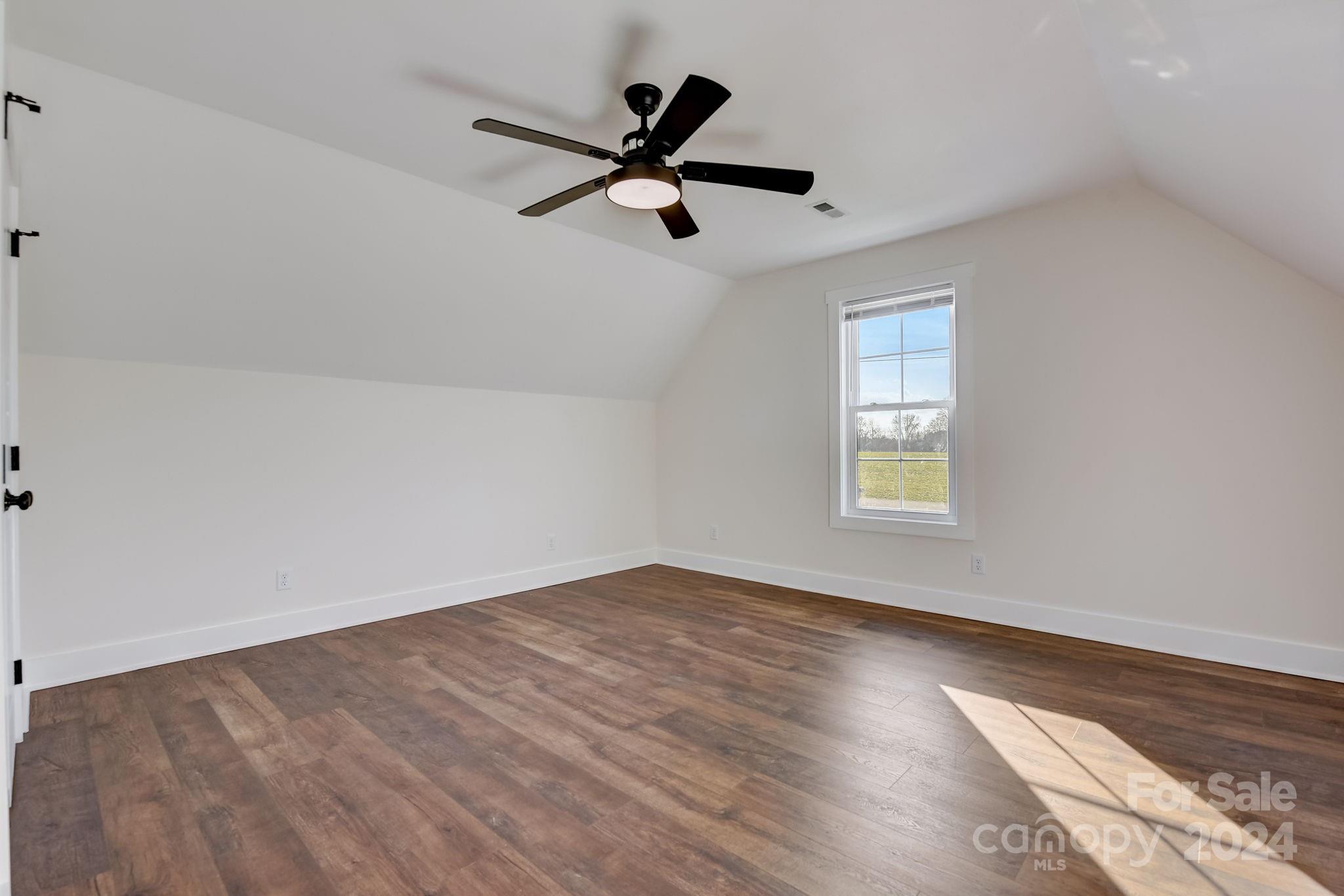 315 Cal Kennedy Road Cleveland, NC 27013 - Photo 27 of 39 wooden floor in an empty room with a window