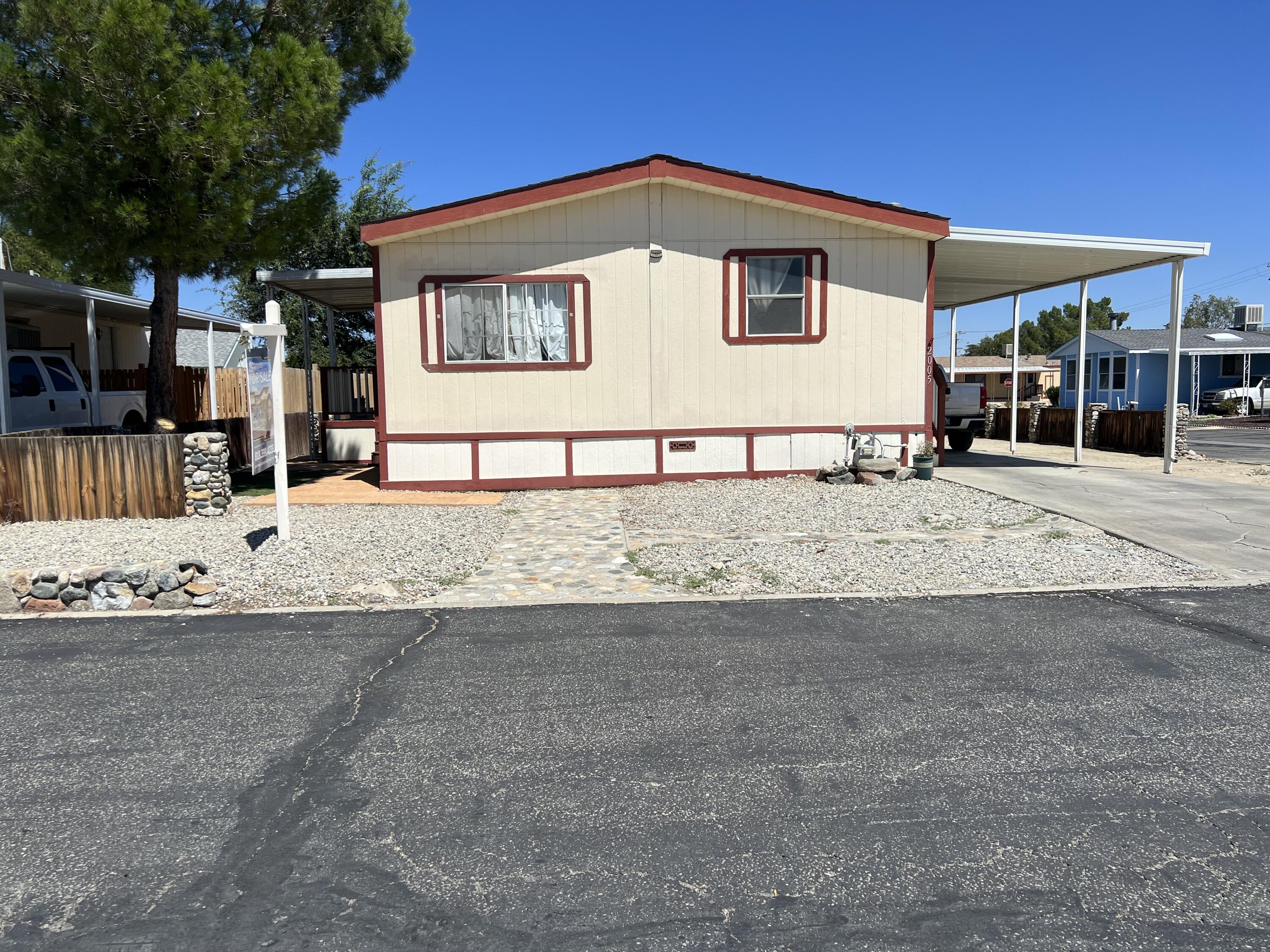 a front view of a house with a road