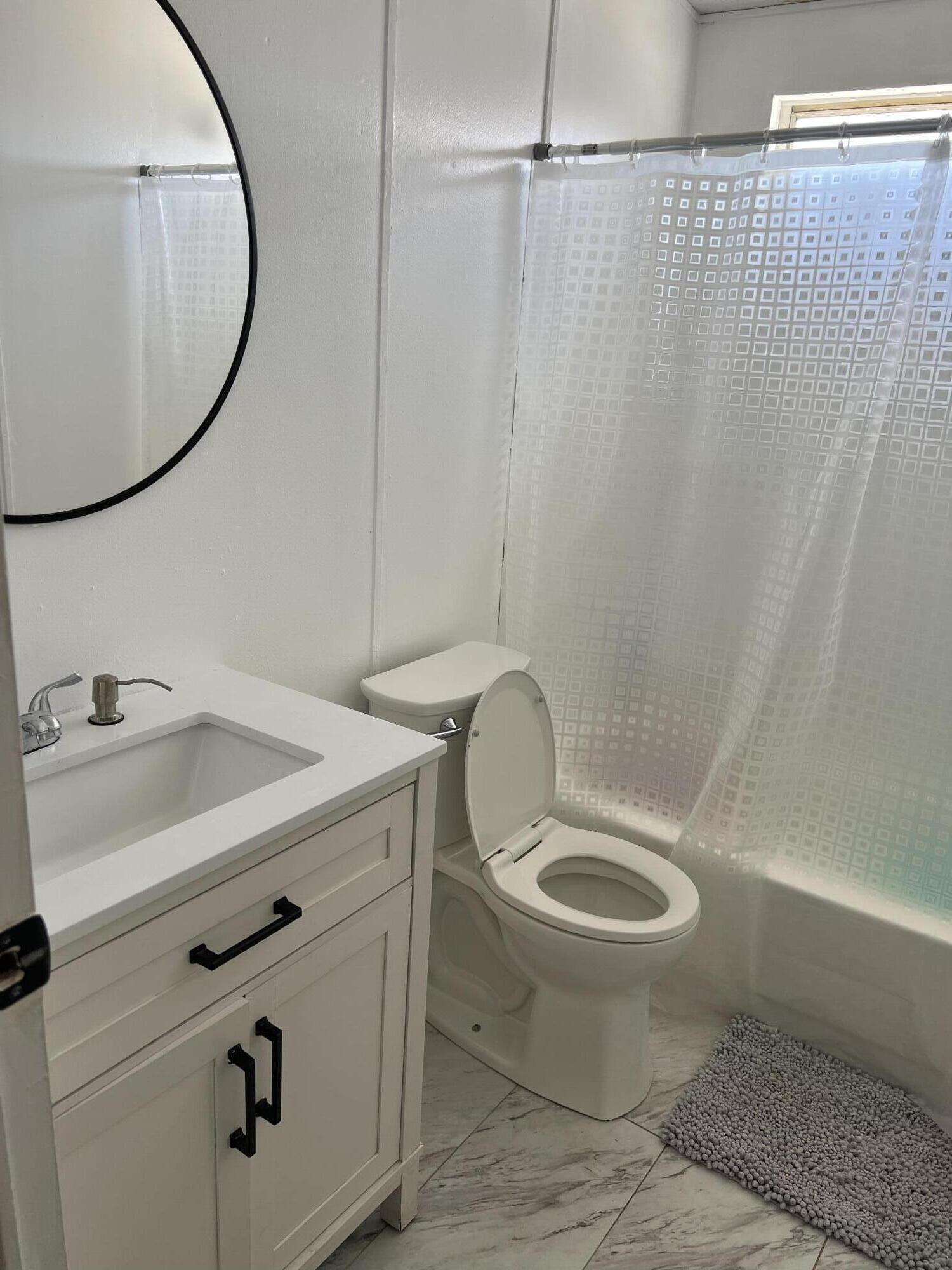 2005 Windcurrent Drive Rosamond, CA 93560 - Photo 11 of 13 a bathroom with a sink a toilet and a mirror