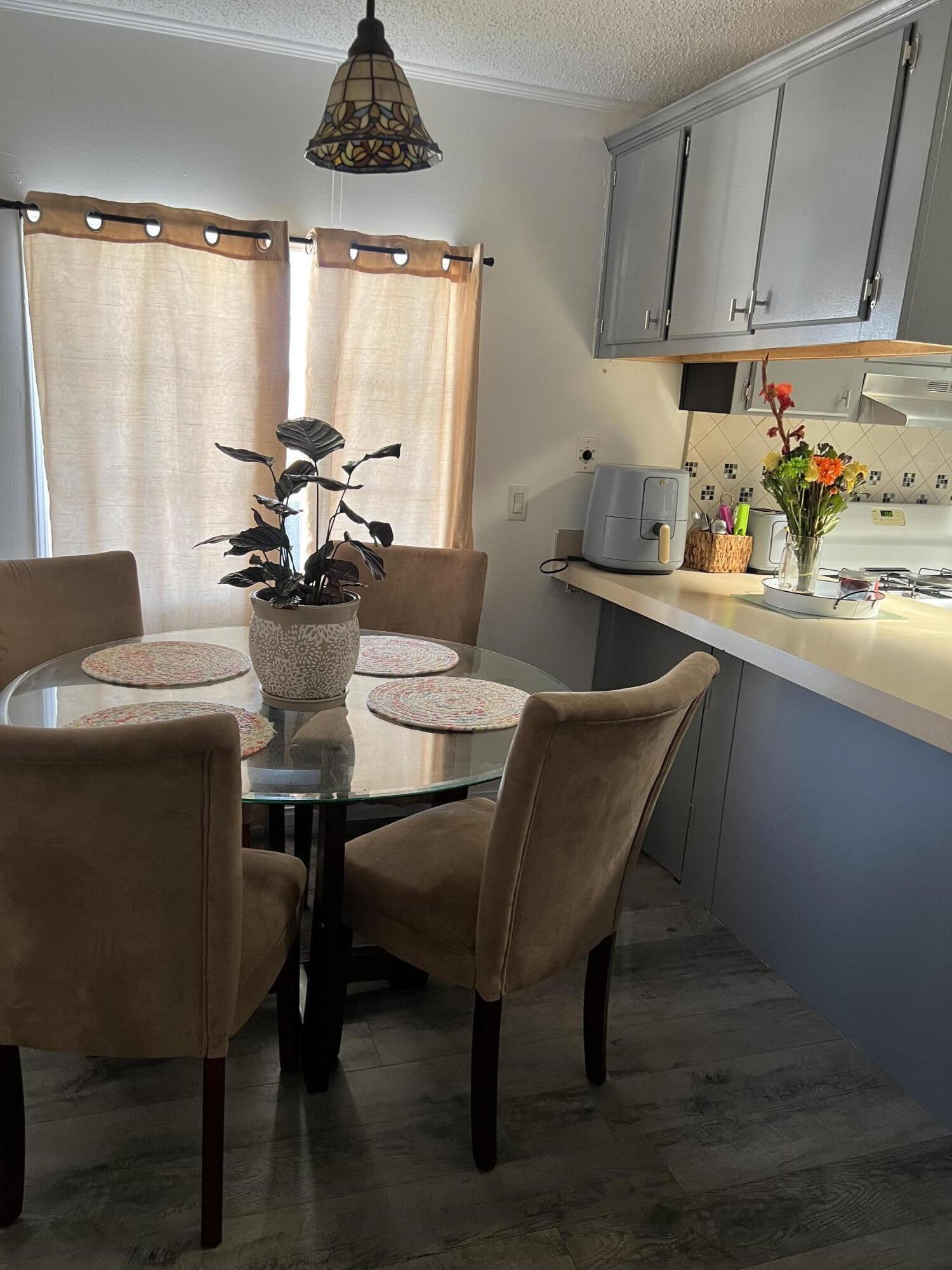 2005 Windcurrent Drive Rosamond, CA 93560 - Photo 6 of 13 a kitchen with a table chairs a stove and a window