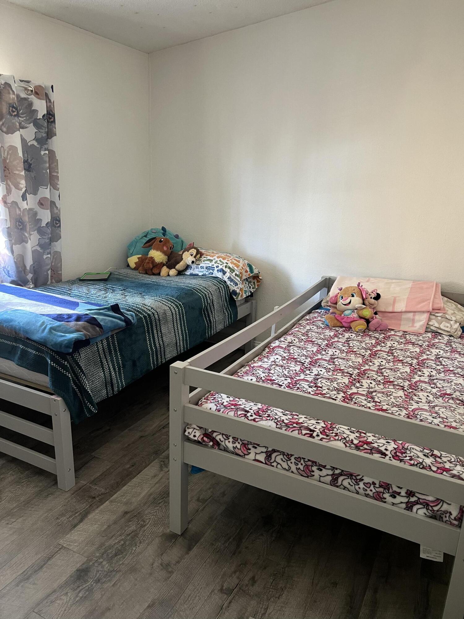 2005 Windcurrent Drive Rosamond, CA 93560 - Photo 10 of 13 a bedroom with a bed and a lamp
