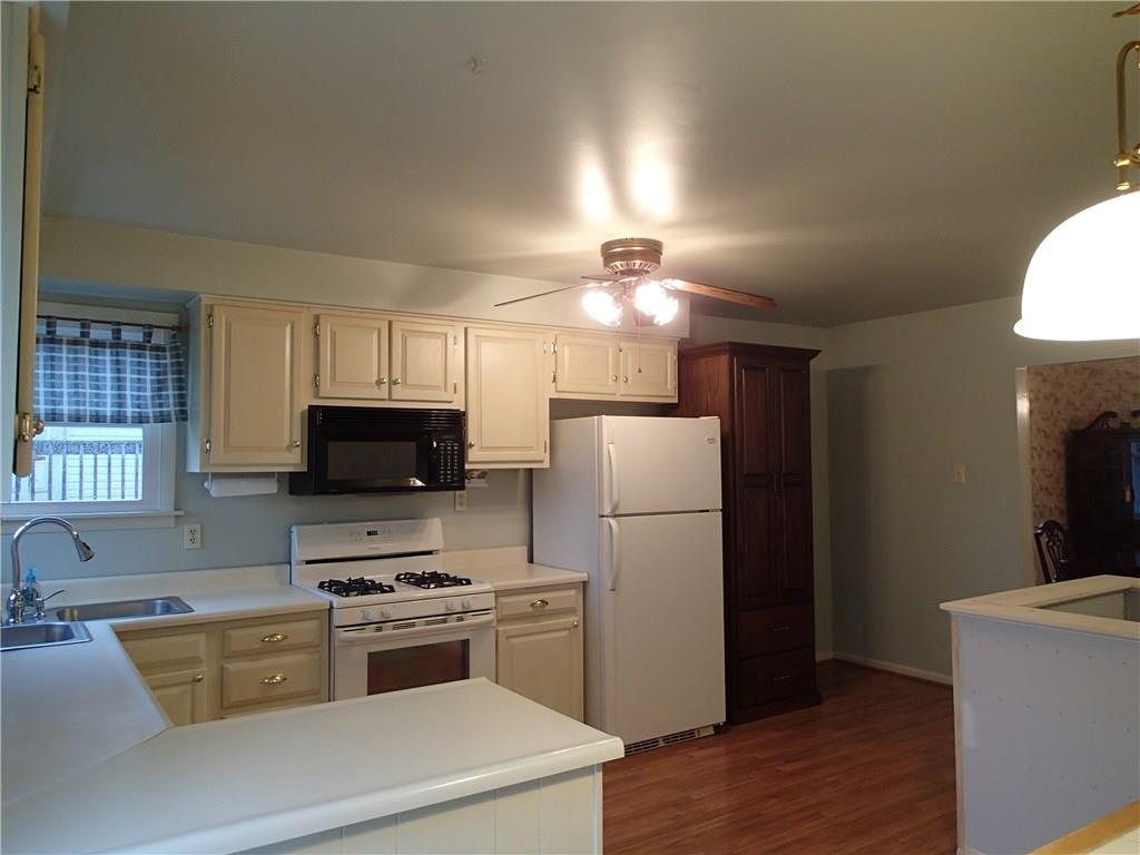 The kitchen is the heart of this home! Darker Pantry cabinet will stay beside refrigerator!