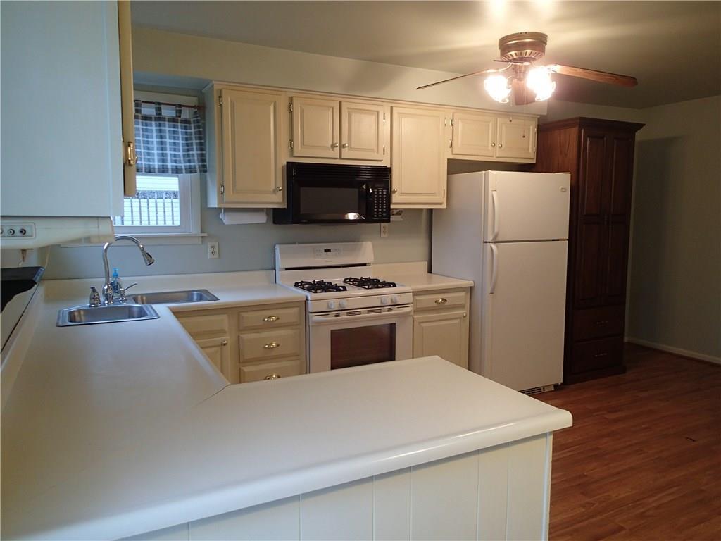 Plenty of counter space and corner sink with two windows to allow in light!