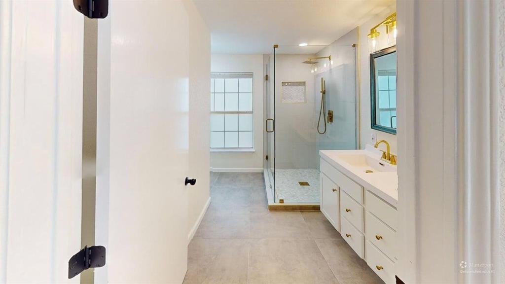2012 Tennessee Avenue Dallas, TX 75224 - Photo 14 of 19 a bathroom with a double vanity sink and mirror