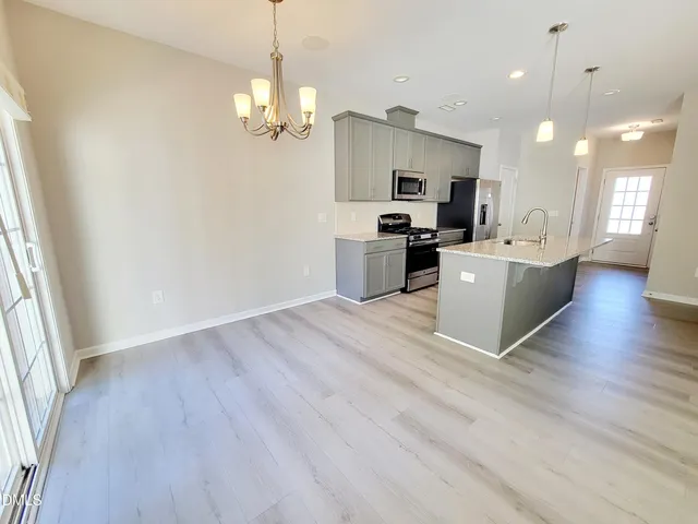 a view of a kitchen with a sink cabinets and wooden floor