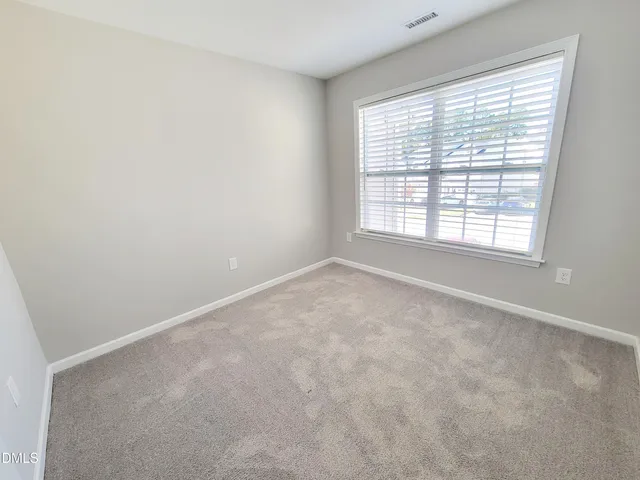 a bathroom with a double vanity sink mirror and toilet