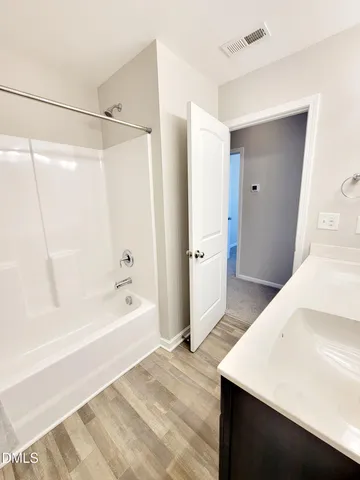 a view of an house with backyard and trees