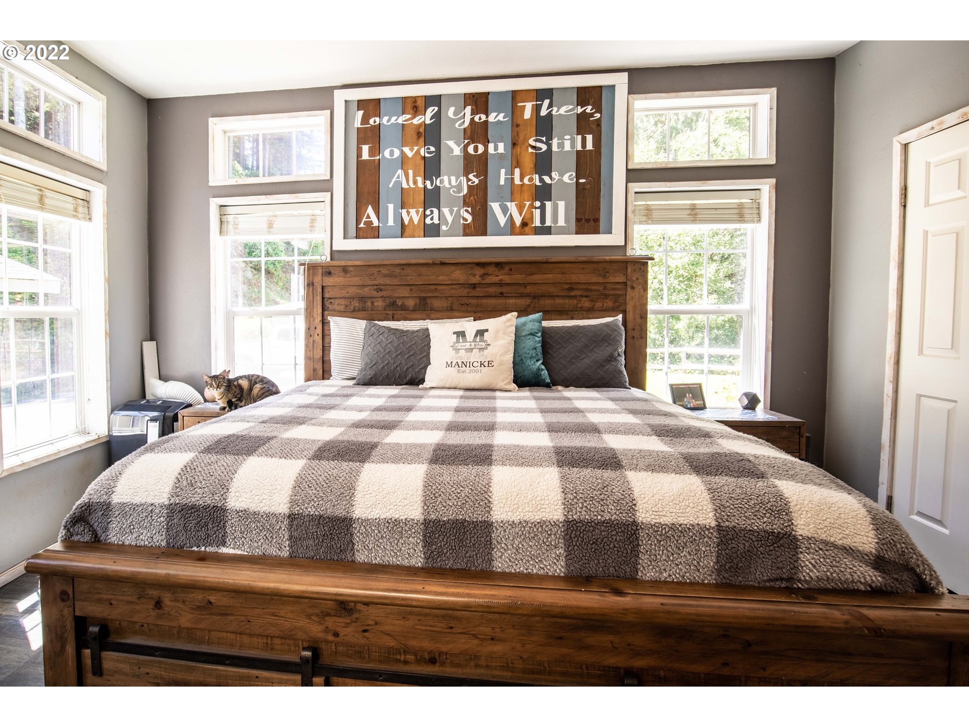 1578 Scholfield Road Reedsport, OR 97467 - Photo 11 of 37 a bedroom with a bed and wooden floor