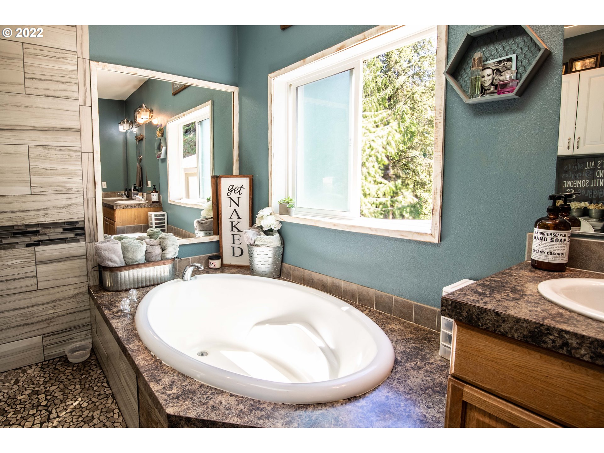 1578 Scholfield Road Reedsport, OR 97467 - Photo 14 of 37 a bathroom with a granite countertop sink and a mirror